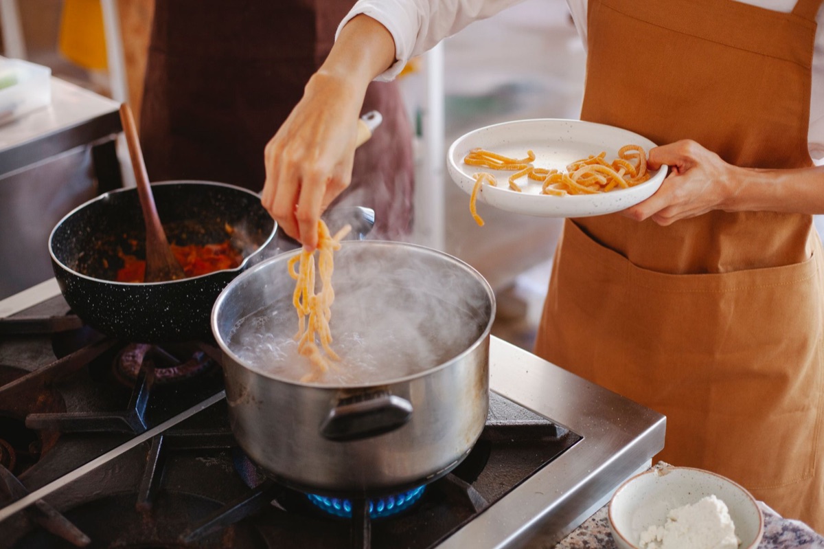 Italian chef cooking pasta