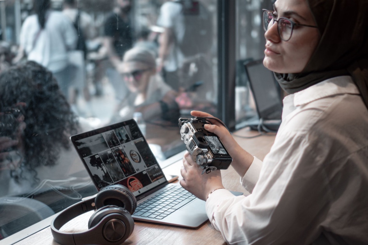 Radio journalist with laptop and camera