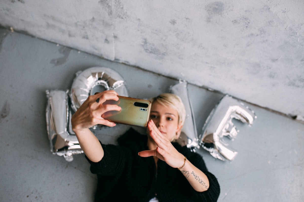 Italian influencer using smartphone in urban setting